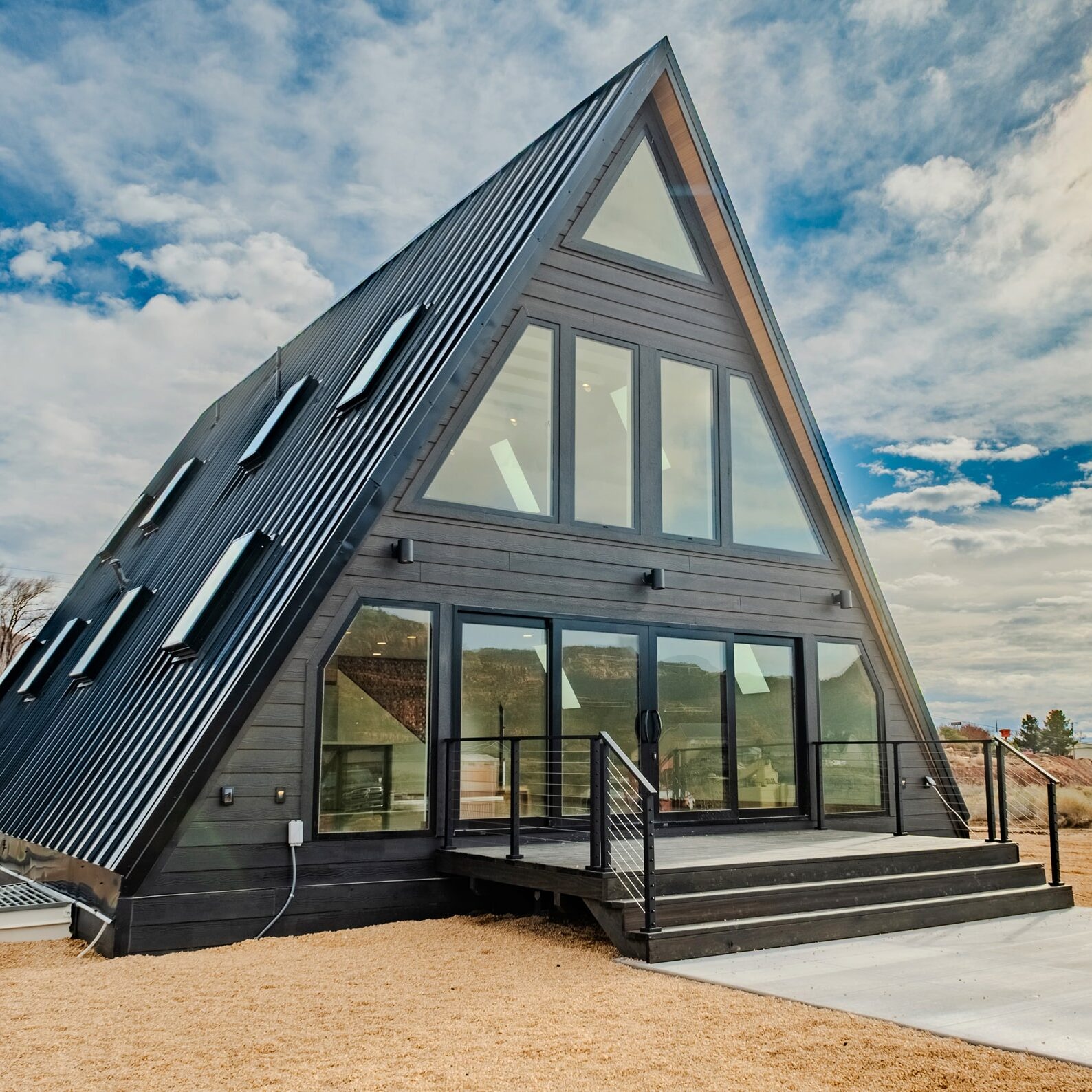 A-Frame custom home in Kanab, Utah, featuring large glass windows, modern design, and a sloped roof, showcasing Oak-n-Crete's innovative architecture.